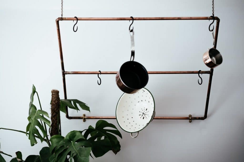 pots hanging on a ceiling rack