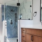 Modern bathroom remodel in Purcellville, VA with a frameless glass shower wall and neutral tones.