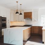Remodeled kitchen in Herndon, VA featuring warm lighting, neutral tones, and functional design.