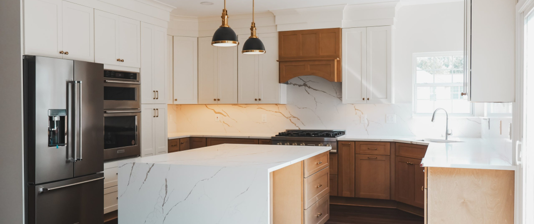 Remodeled kitchen in Herndon, VA featuring warm lighting, neutral tones, and functional design.