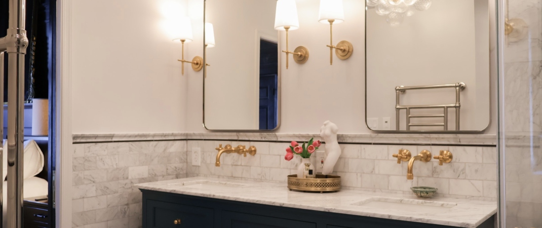 Modern bathroom with gold accents and glass shower door in Alexandria remodel